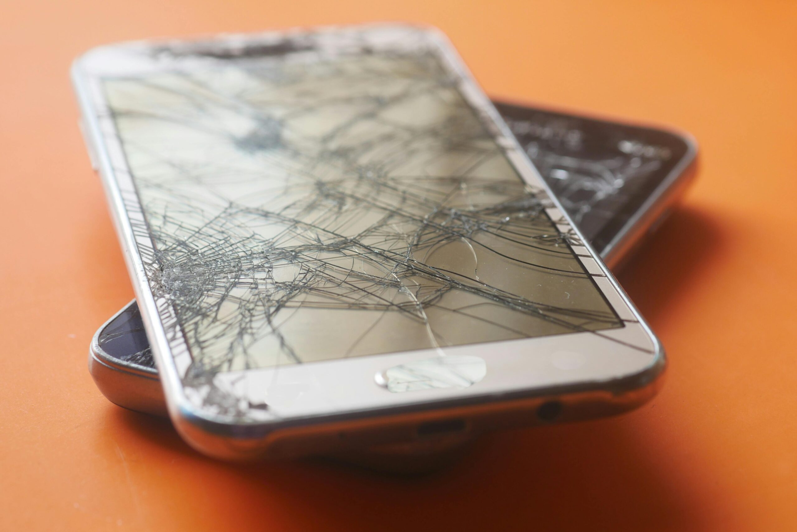 broken smartphones with cracked screens
